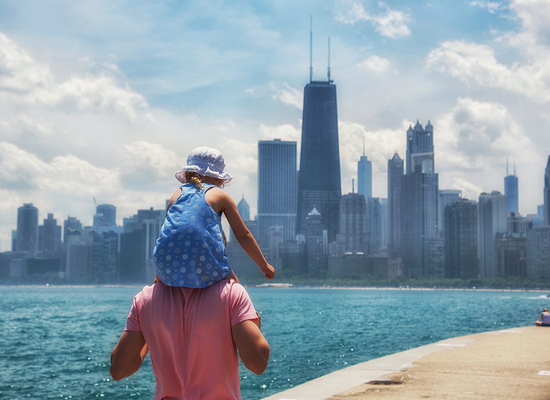 About Our Agency - Little Girl Sitting on the Shoulders of Her Father While Looking at Chicago in the Distance