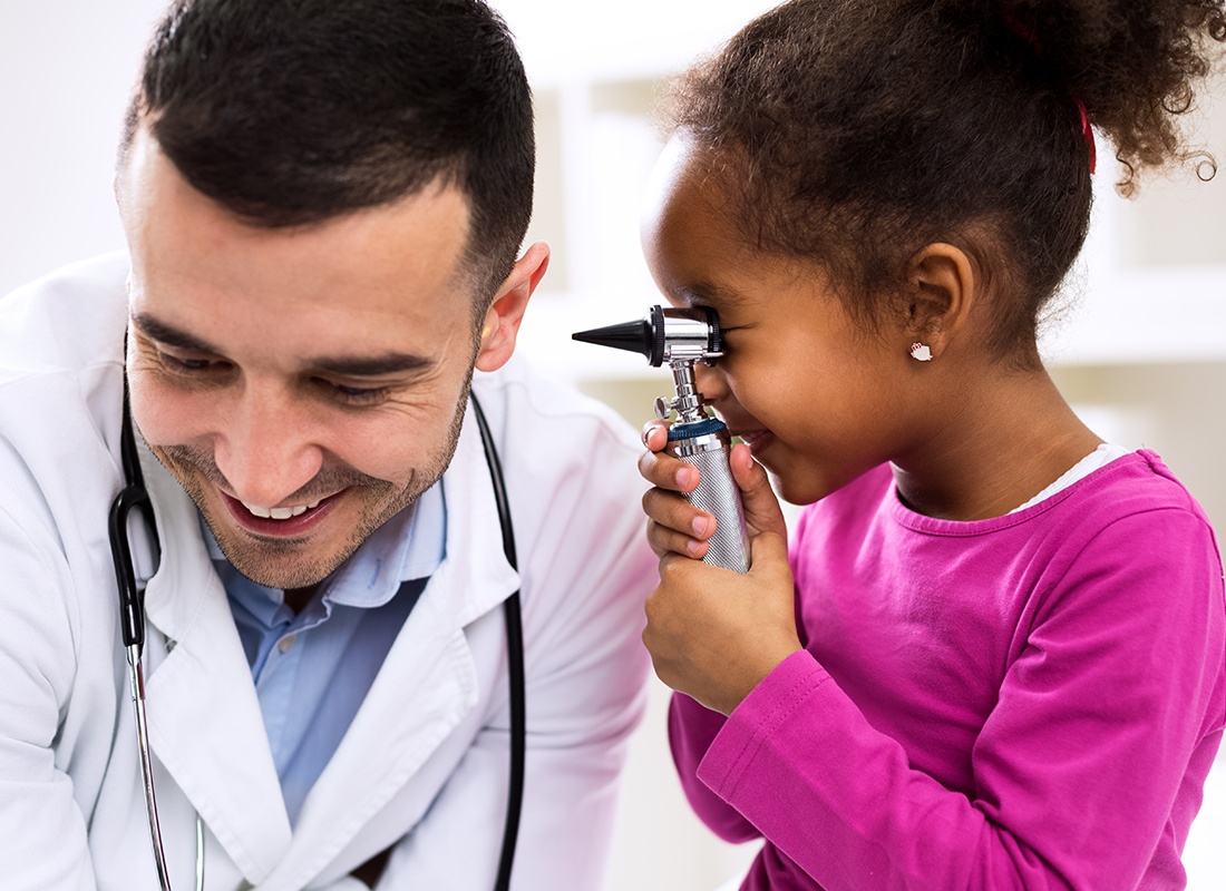 Personal Insurance - Little Girl Playing With Doctor at Her Appointment